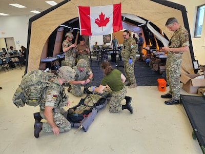 In September 2025, scientists from the Walter Reed Army Institute of Research—West participated in a collaborative effort with Baylor University and U.S. Army Combat Capabilities Development Command to collect data measuring physiological and psychological factors affecting combat medic performance during simulated patient encounters at Bold Quest 2025. Pictured are combat medics from United Kingdom coalition partners, following initial point of injury care, preparing to hand off a patient to the Role 1 care medical team. This photo has been edited.
