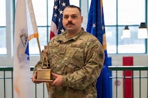 Airman holds an award.