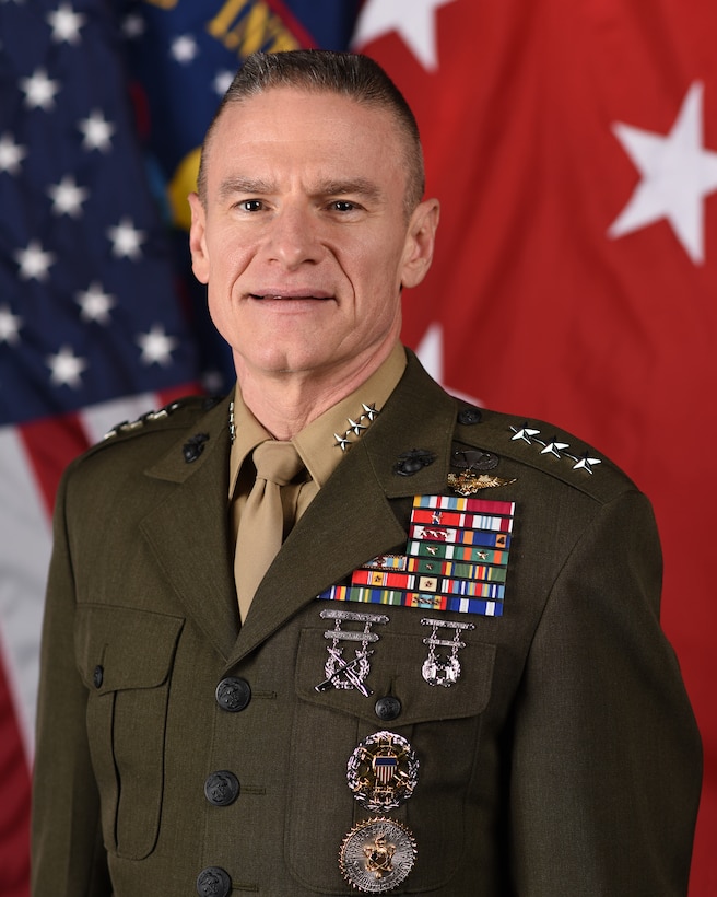 A photo of a decorated military man in service dress clothing.