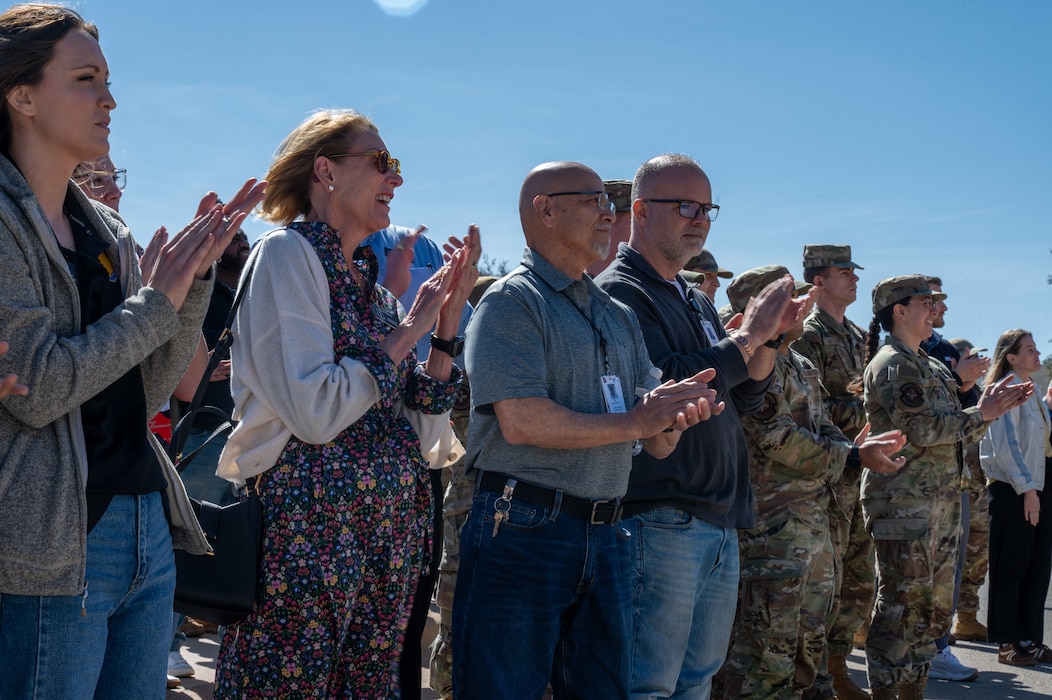 A low angle photo of a crowd clapping.
