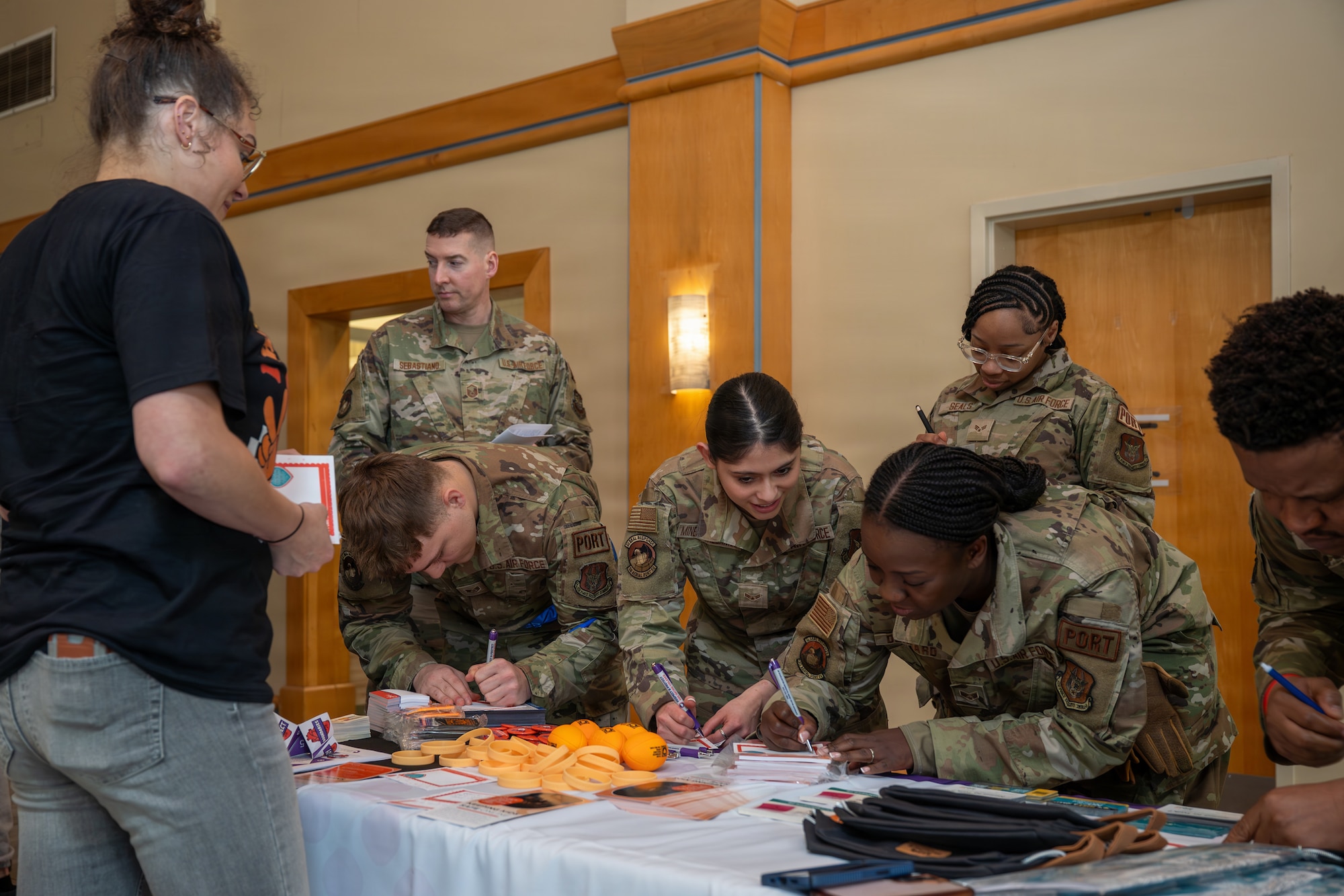 Airmen from Joint Base Charleston write letters and discuss the importance of teenage dating violence awareness.