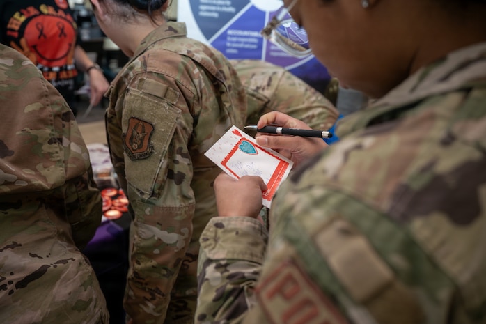 Airmen from Joint Base Charleston write letters in support of teenage dating violence awareness month.