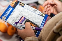 An Airman from Joint Base Charleston holds a resource manual with information on teenage dating.
