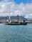 A barge sits with a crane on top of it in the waters of Kahului Harbor, Maui.