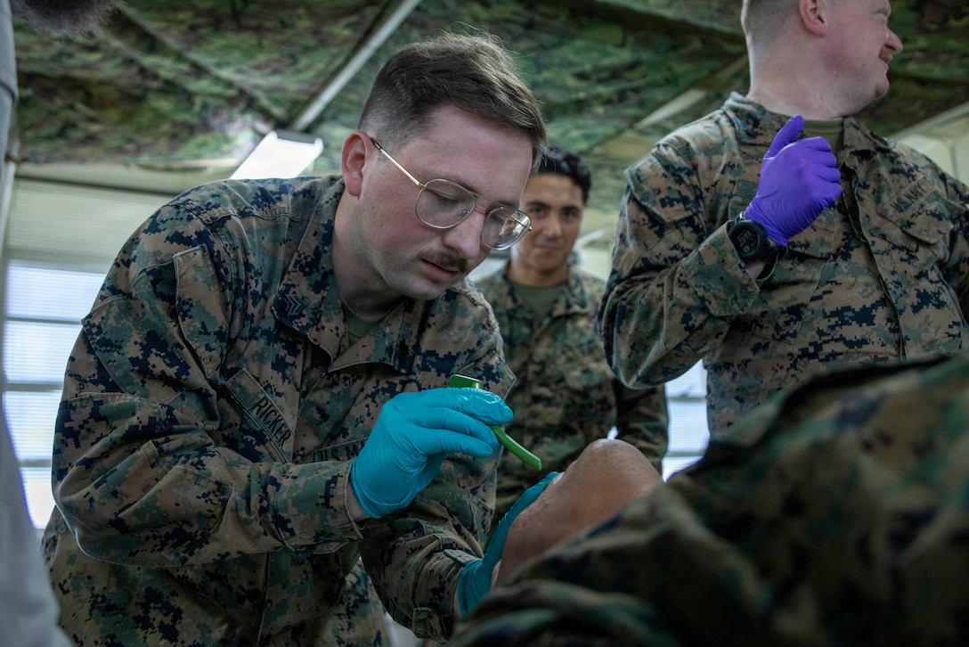 U.S. Marine Corps Sgt. Jackson Ricker, a combat videographer with III Marine Expeditionary Force, prepares a simulated casualty for a nasopharyngeal airway insertion during a Combat Lifesaver Course, Camp Hansen, Okinawa, Japan, Jan. 6, 2025. The 40-hour course prepares Marines to treat wounded service members, prevent additional casualties, and complete their missions while in combat. Ricker is a native of Colorado. (U.S. Marine Corps photo by Lance Cpl. Robert Blanks)