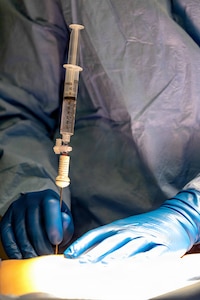 Lt. Cmdr. James Martinson, from Sykesville, Maryland, temporarily assigned to Pre-Commissioning Unit John F. Kennedy (CVN 79) from USS Harry S. Truman (CVN 75), performs the ship’s first at-sea surgery which occurred during Builder’s Trials, Feb. 1, 2026. Builder’s Trials provide an opportunity to test ship systems and components at sea for the first time, and make required adjustments prior to additional underway testing.  (U.S. Navy photo by Mass Communication Specialist 1st Class Tyrell K. Morris)