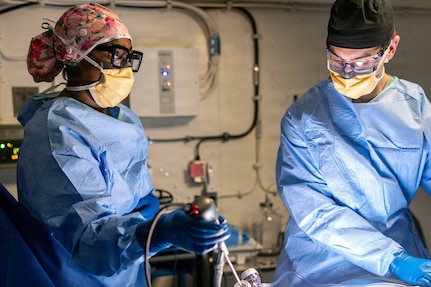 Hospital Corpsman 2nd Class Rashidah Parker, left, from Killeen, Texas, and Lt. Cmdr. James Martinson, from Sykesville, Maryland, perform the first at-sea surgery aboard Pre-Commissioning Unit John F. Kennedy (CVN 79) during Builder’s Trials, Feb. 1, 2026. Builder’s Trials provide an opportunity to test ship systems and components at sea for the first time, and make required adjustments prior to additional underway testing.  (U.S. Navy photo by Mass Communication Specialist 1st Class Tyrell K. Morris)