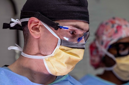 Lt. Cmdr. James Martinson, from Sykesville, Maryland, temporarily assigned to Pre-Commissioning Unit John F. Kennedy (CVN 79) from USS Harry S. Truman (CVN 75), performs the ship’s first at-sea surgery which occurred during Builder’s Trials, Feb. 1, 2026. Builder’s Trials provide an opportunity to test ship systems and components at sea for the first time, and make required adjustments prior to additional underway testing. (U.S. Navy photo by Mass Communication Specialist 1st Class Tyrell K. Morris)