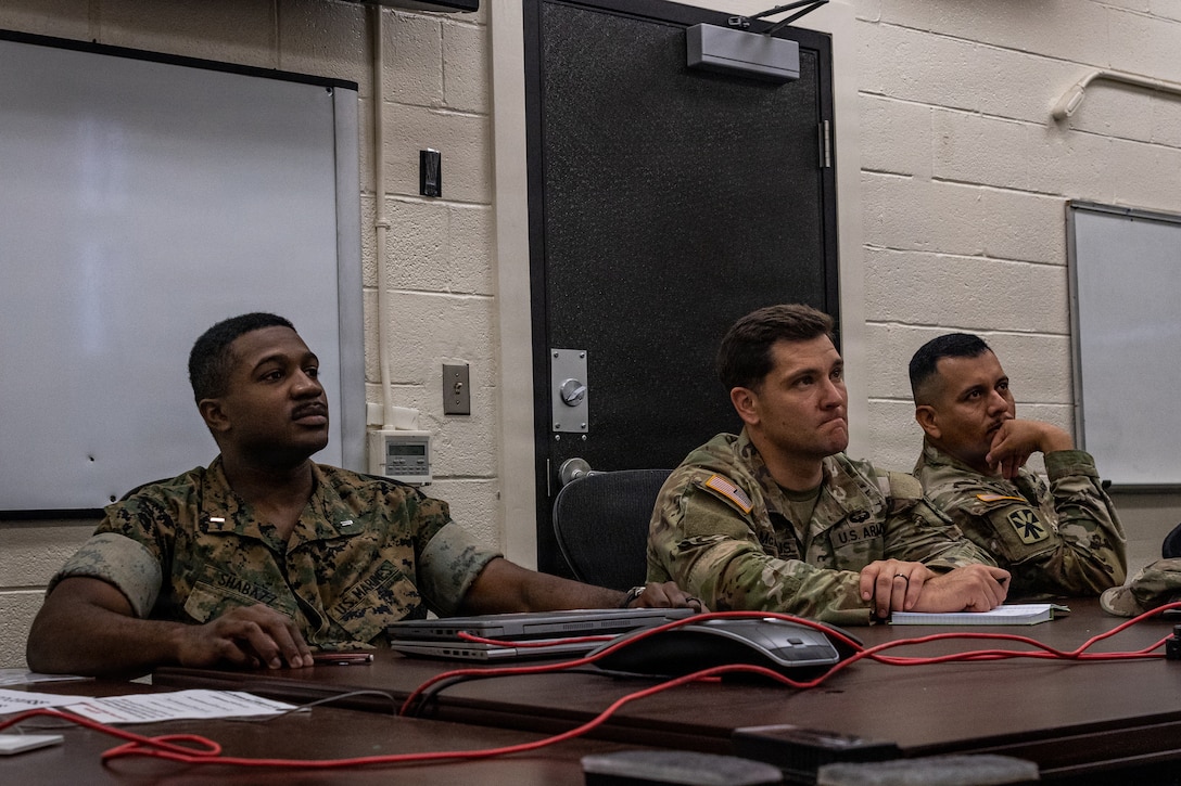 U.S. Marine Corps 1st Lt. Isaiah Shabazz, left, a platoon commander with 3rd Littoral Anti-Air Battalion, 3rd Marine Littoral Regiment, 3rd Marine Division, and U.S. Army soldiers participate in an Air Defense Artillery Fire Control Officer (ADAFCO) course on Marine Corps Base Hawaii, Jan. 15, 2026. The certification of ADAFCOs within 3rd LAAB’s formation equips 3rd MLR with skilled Marines that are capable of managing and coordinating complex air defense operations, seamlessly integrating with joint service air and missile defense systems. Shabazz is a native of Florida.  (U.S. Marine Corps photo by Sgt. Malia Sparks)