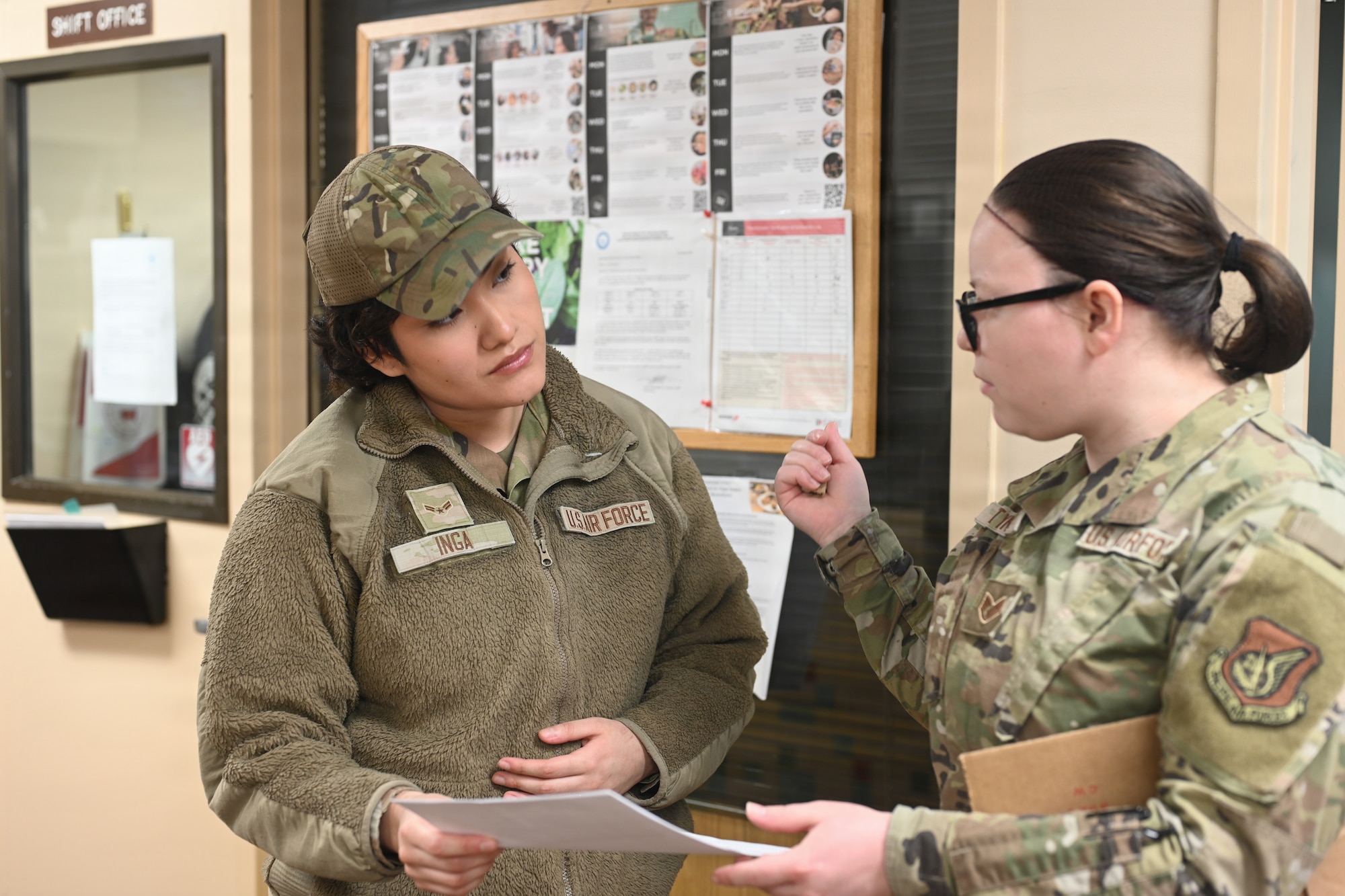 U.S. Air Force Airman 1st Class Ivana Inga, a 673d Force Support Squadron services Airmen, and Staff Sgt. Alexandria Tyner, a 673d FSS production specialist, discuss expenditures at the Iditarod Dining Facility on Joint Base Elmendorf-Richardson, Alaska, Feb. 3, 2026. Inga has served on JBER for three years and has fueled warfighting abilities as a preparation cook, server, and most recently an accountant. (U.S. Air Force photo by Airman 1st Class Eli A. Rose)