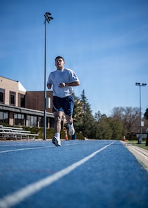 An Airman runs on the track.