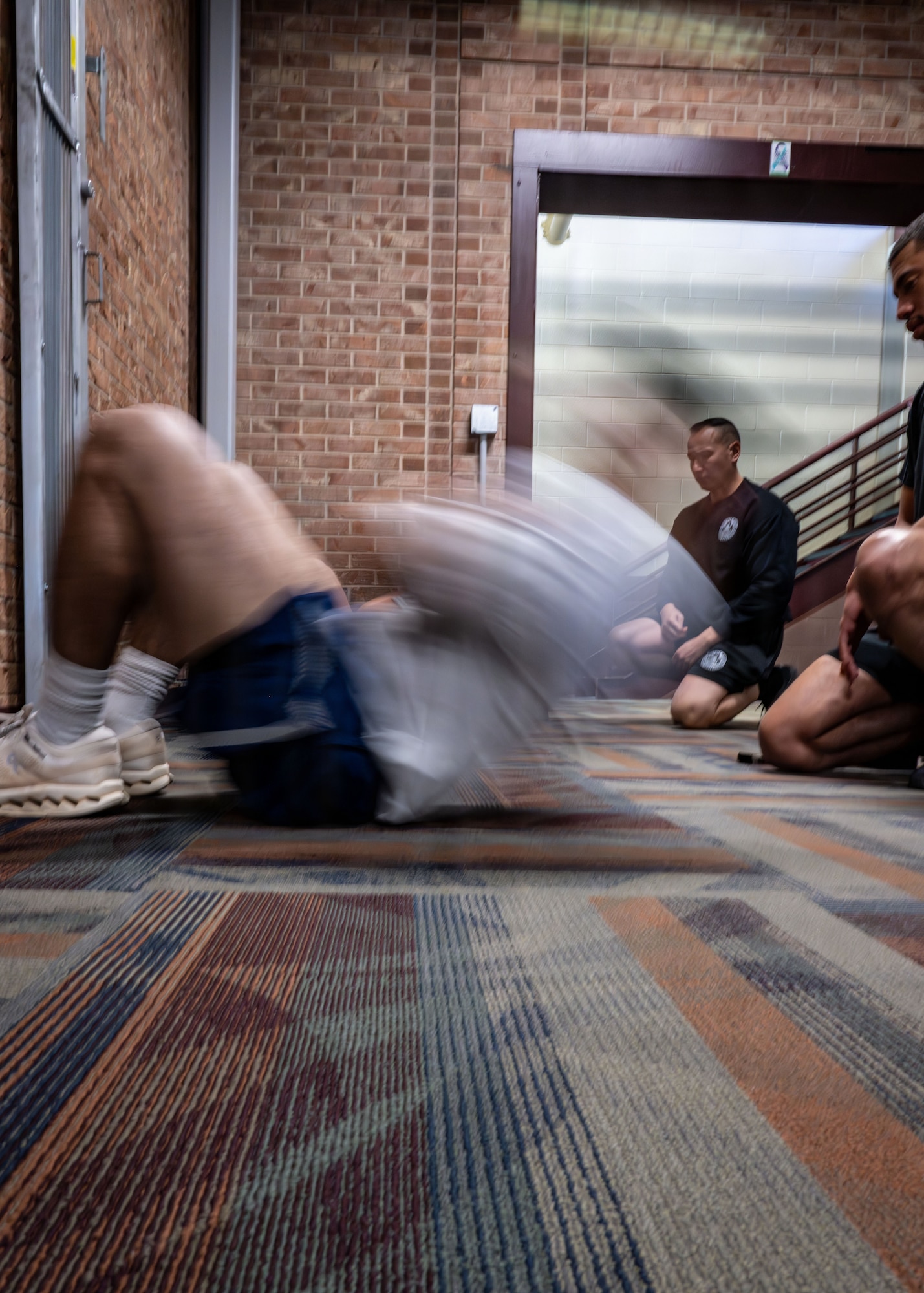 An Airman performs a sit up.