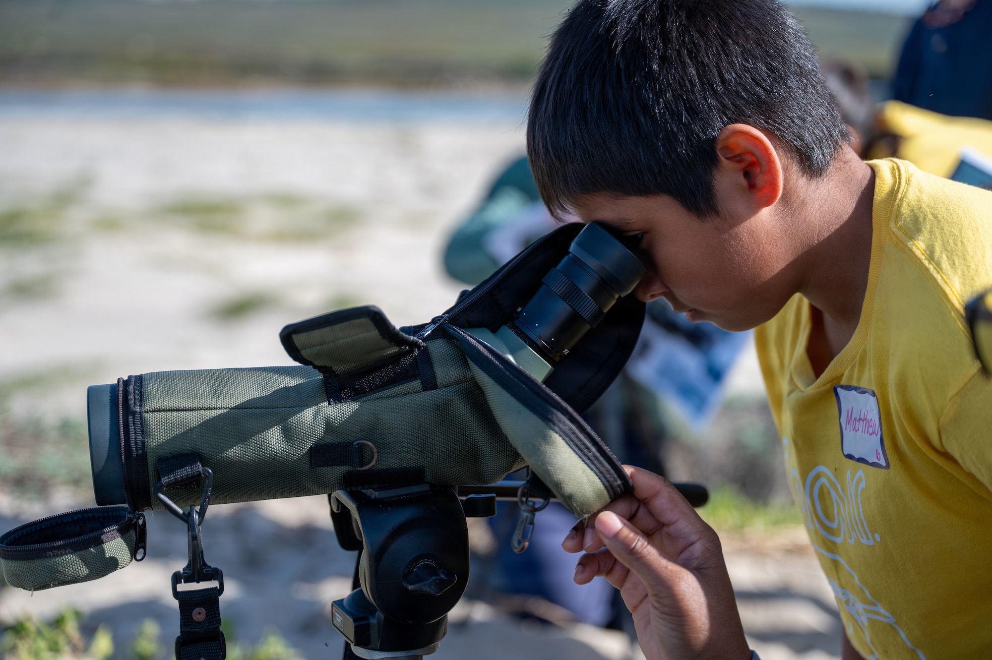 A student from Lompoc Unified School District looks through a spotting scope during a wildlife education field trip at Ocean Park.