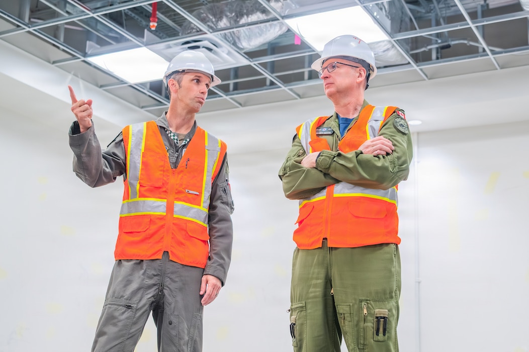 U.S. Air Force Lt. Col. Shayne Carroll (left), 308th Fighter Squadron commander, and Royal Canadian Air Force Maj. Gen. Jeff Smyth (right), RCAF chief of air and space force development, discuss the facilities under construction during a base visit, Feb. 18, 2026, at Luke Air Force Base, Arizona.