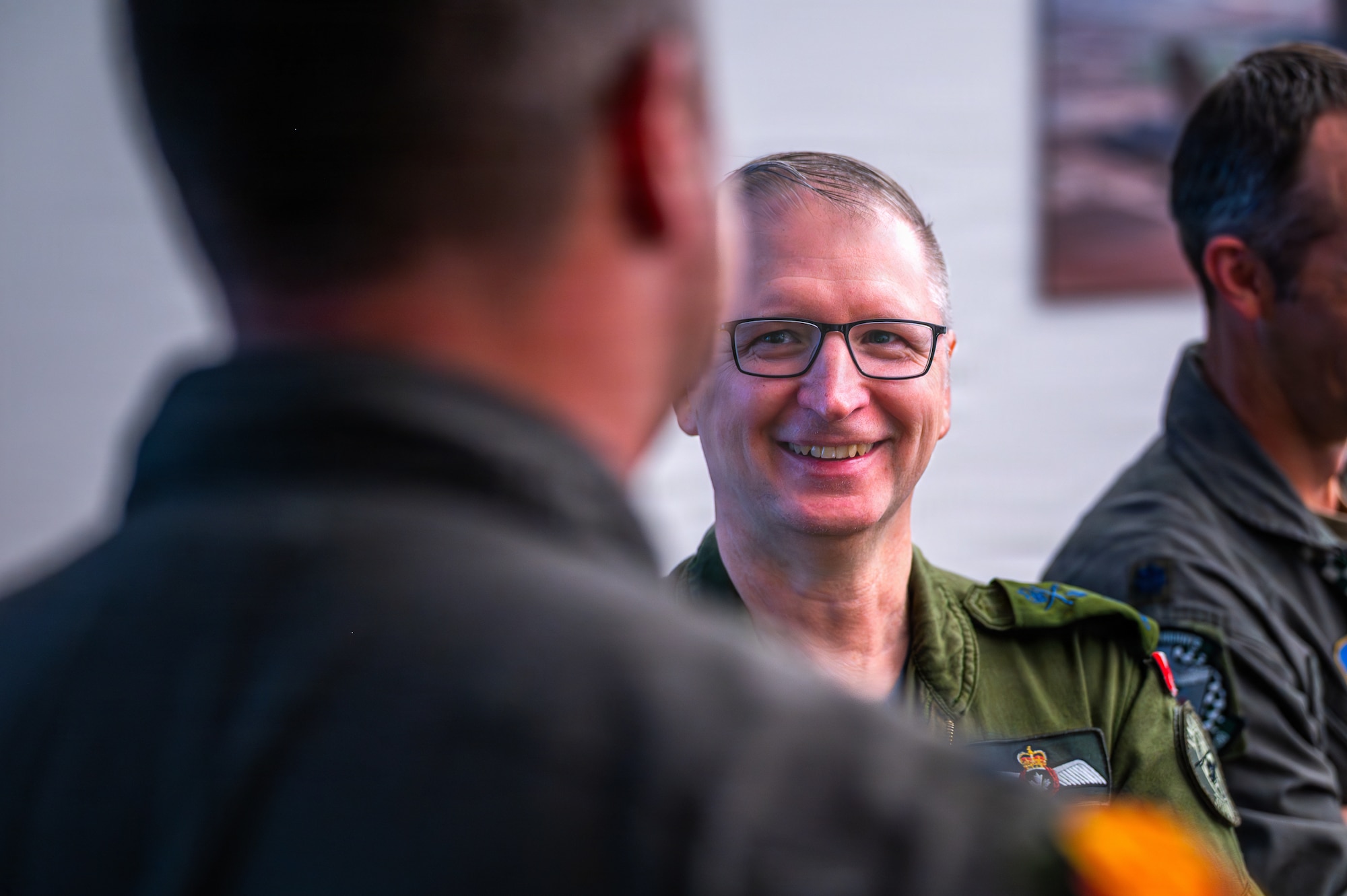 Royal Canadian Air Force Maj. Gen. Jeff Smyth, RCAF chief of air and space force development, speaks with U.S. Air Force Col. John Ryan, 56th Fighter Wing deputy commander, prior to attending a wing mission brief during a base visit, Feb. 18, 2026, at Luke Air Force Base, Arizona.