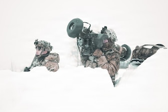 A U.S. Army Soldiers assigned to 1st Battalion, 5th Infantry Regiment, 1st Infantry Brigade Combat Team (Air Assault), 11th Airborne Division positions himself with a FGM-148 Javelin simulated opposing force during Joint Pacific Multi-National Readiness Center 26-02 on the Yukon Training, Alaska Feb. 22, 2026.