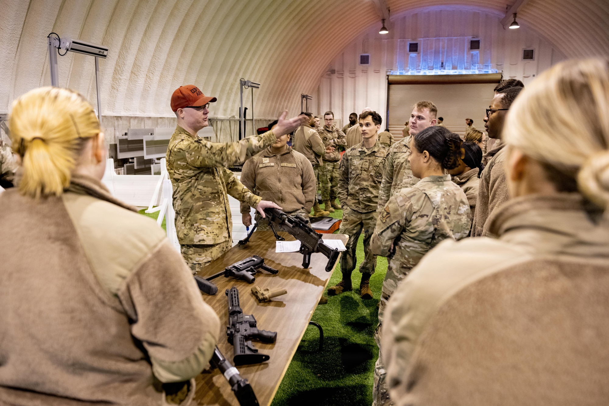 U.S. Airmen receive a combat arms training mission and weapon maintenance brief during an immersion tour.