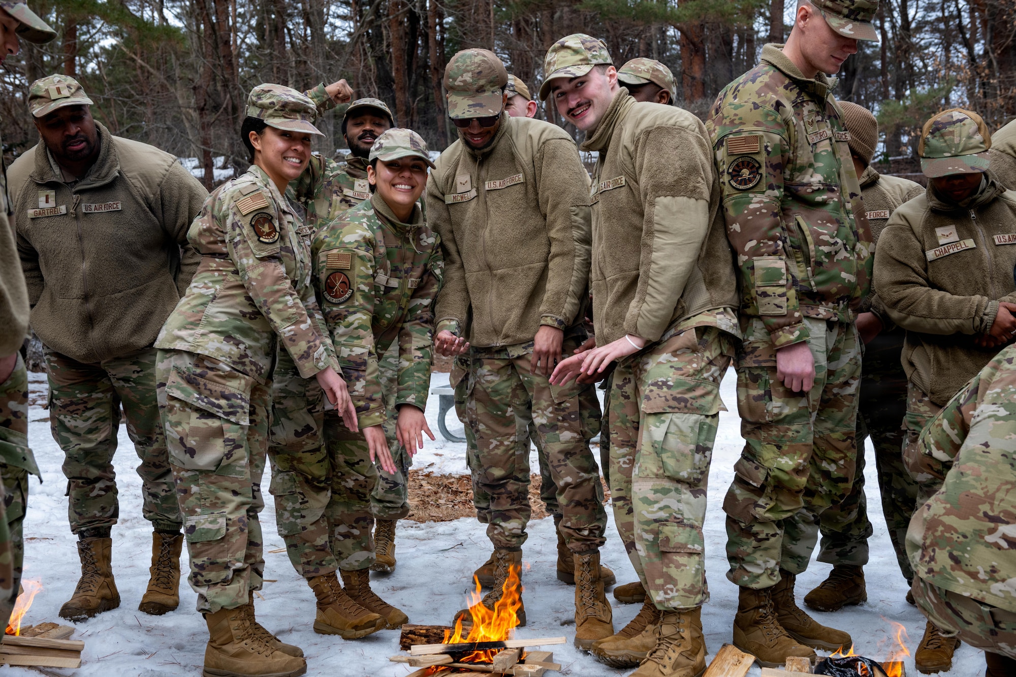U.S. Airmen assigned to the 35th Fighter Wing pose by their campfire during an immersion tour.