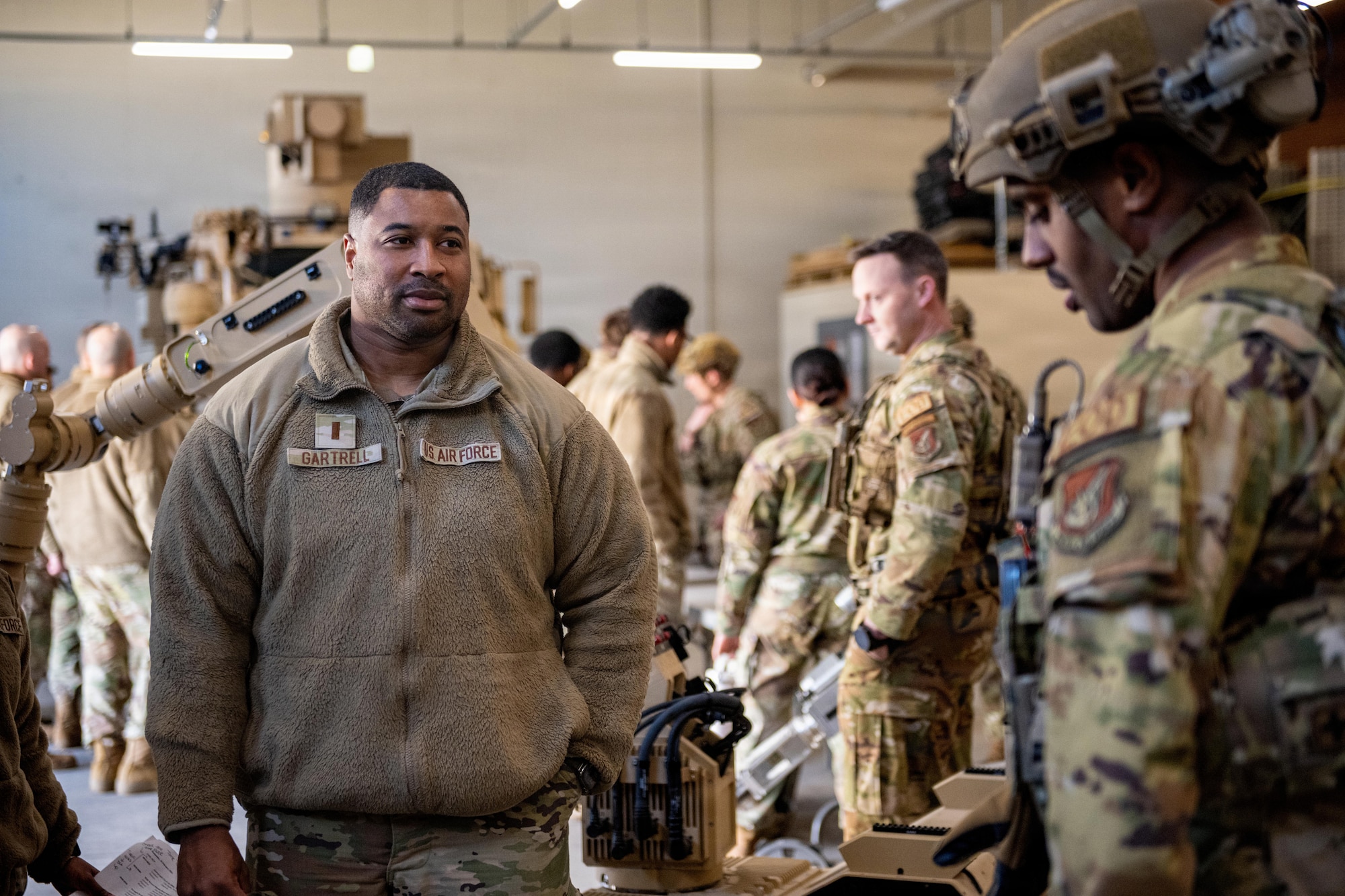 U.S. Air Force 2nd Lt. Quentin Gartrell, left, 35th Maintenance Squadron aerospace ground equipment flight commander, listens to an explosive ordnance disposal job brief during an immersion tour.