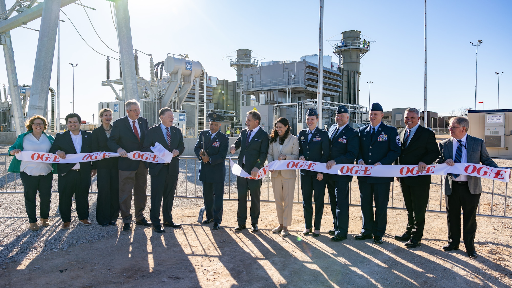 Group of people cut ribbon at power plant