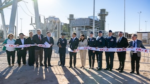 Group of people cut ribbon at power plant