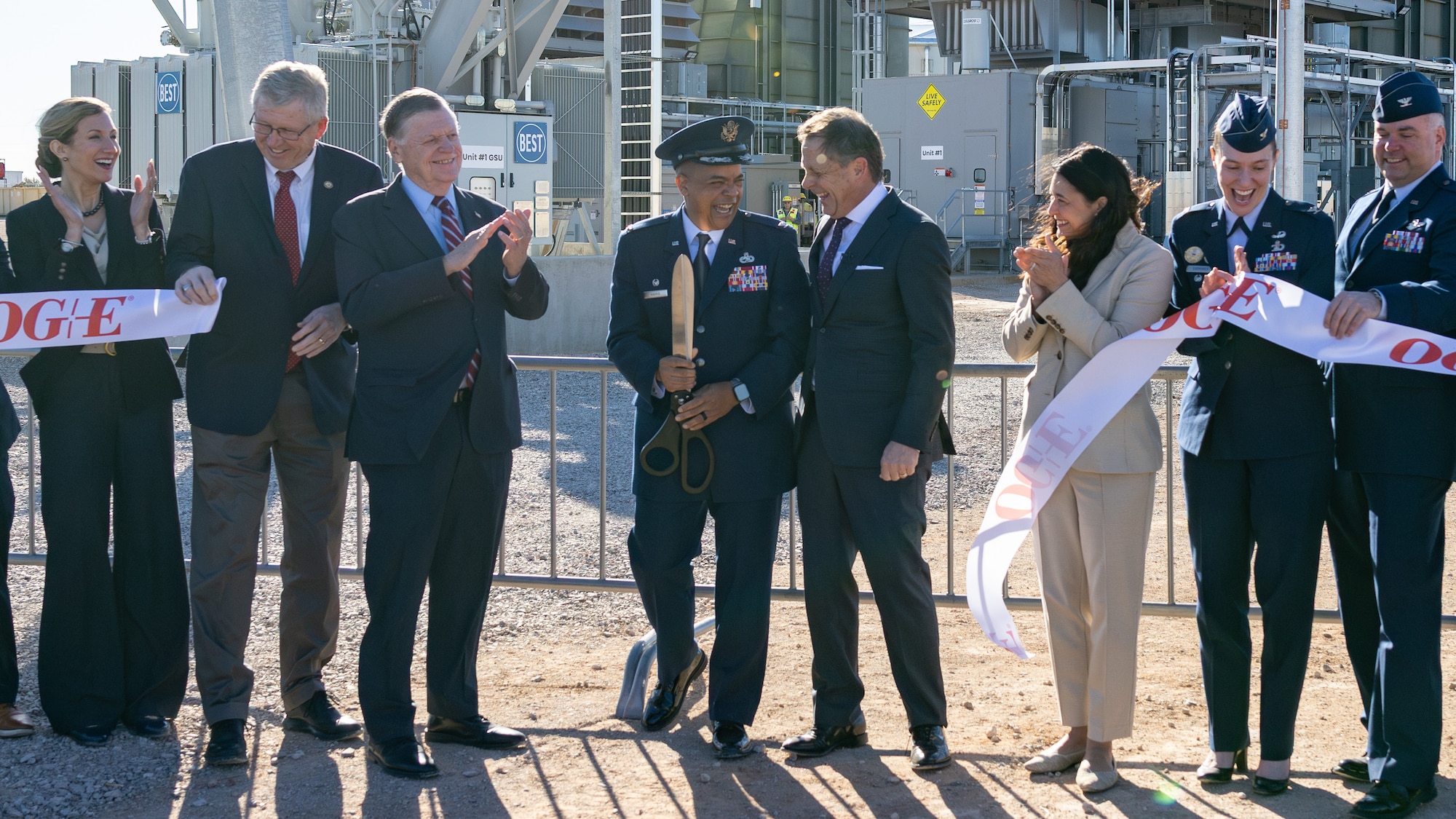 Group of people celebrating ribbon cutting at power plant