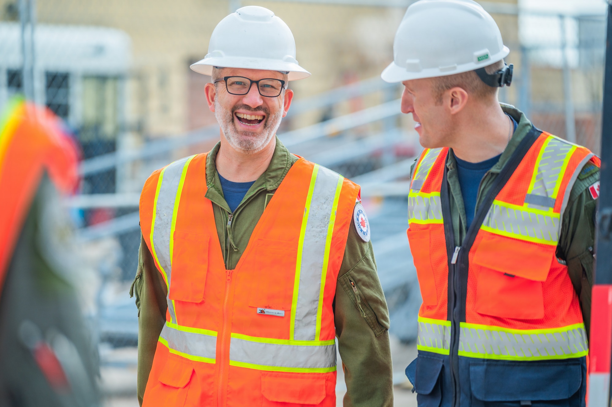 Royal Canadian Air Force Col. Barry Leonard (left), Canadian forces air and space attaché, speaks with a RCAF pilot while touring the build site for the new 309th Fighter Squadron during a base visit, Feb. 18, 2026, at Luke Air Force Base, Arizona.