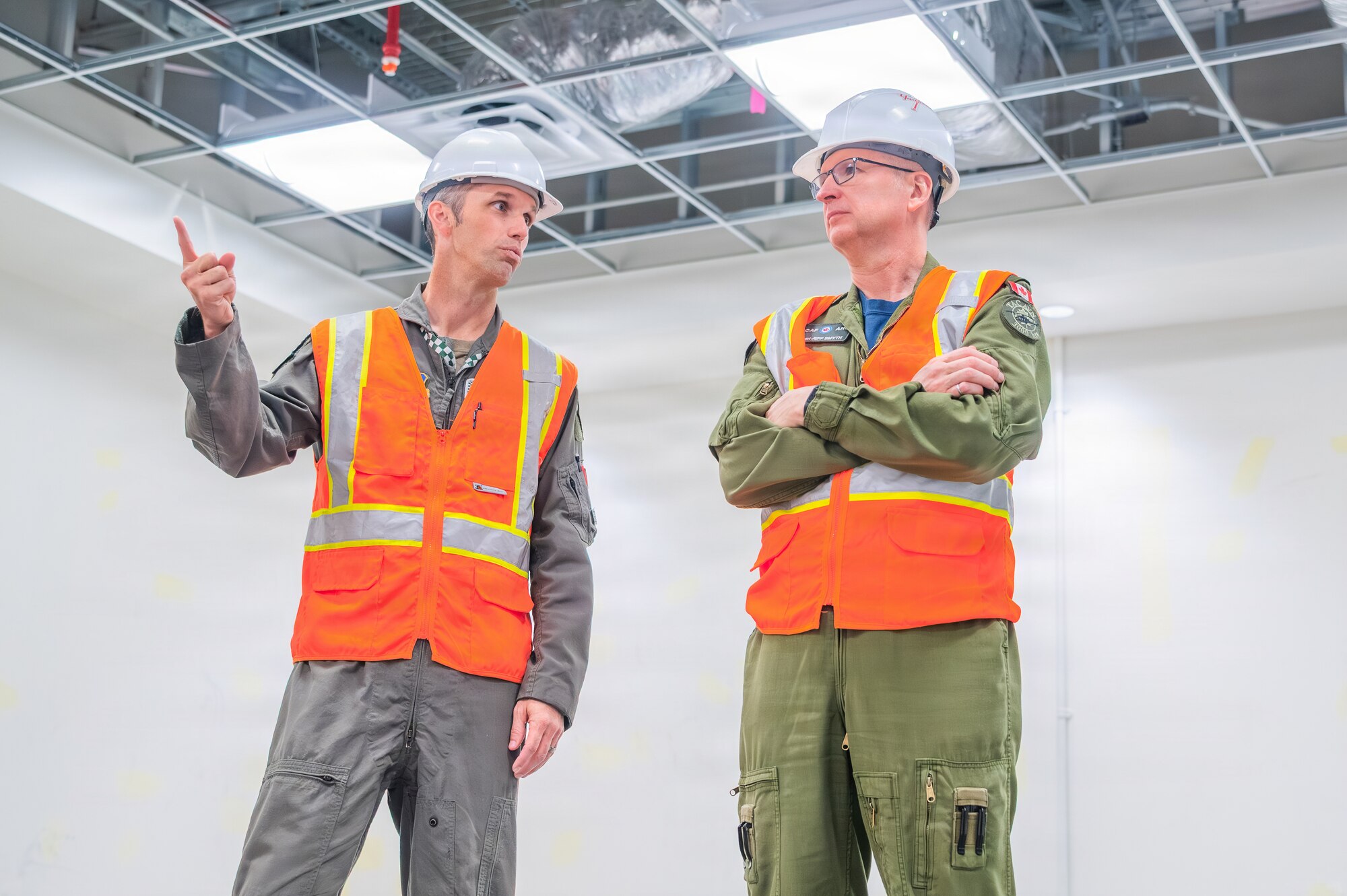 U.S. Air Force Lt. Col. Shayne Carroll (left), 308th Fighter Squadron commander, and Royal Canadian Air Force Maj. Gen. Jeff Smyth (right), RCAF chief of air and space force development, discuss the facilities under construction during a base visit, Feb. 18, 2026, at Luke Air Force Base, Arizona.
