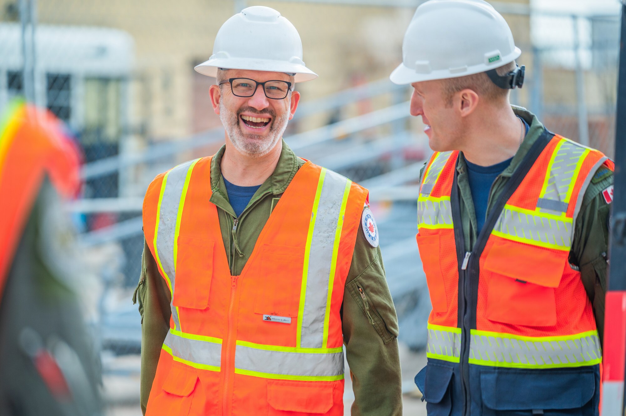 Royal Canadian Air Force Col. Barry Leonard (left), Canadian forces air and space attaché, speaks with a RCAF pilot while touring the build site for the new 309th Fighter Squadron during a base visit, Feb. 18, 2026, at Luke Air Force Base, Arizona.