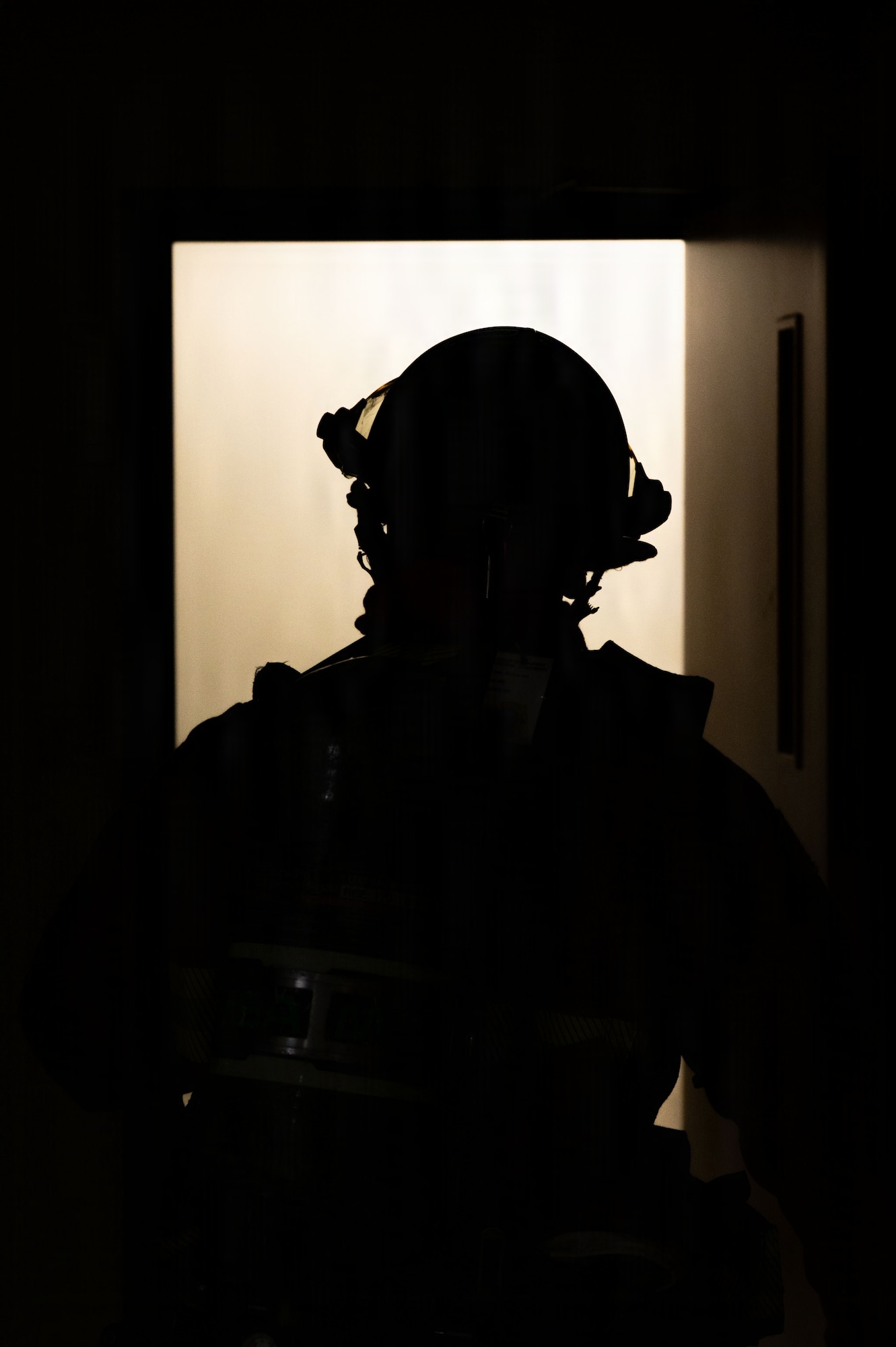 Fire fighter assess room.