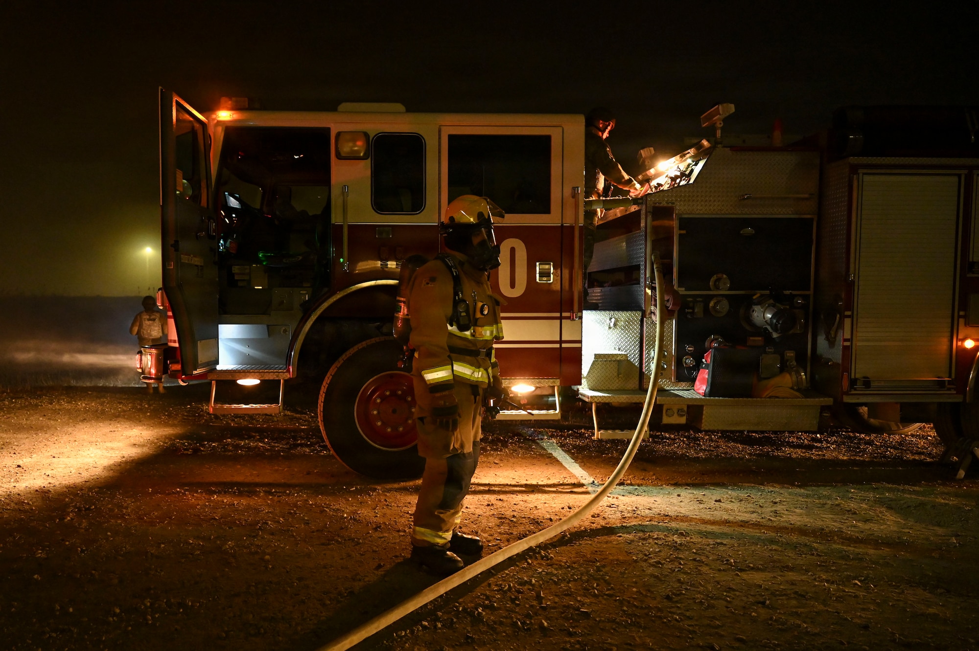 Fire fighter secures hose.