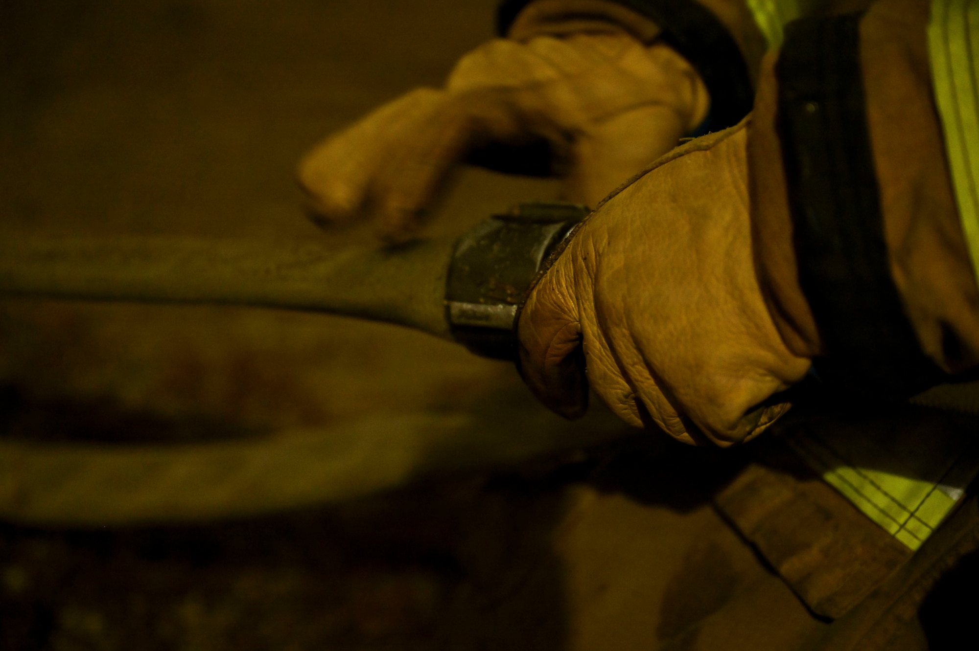 Fire fighter secures hose.