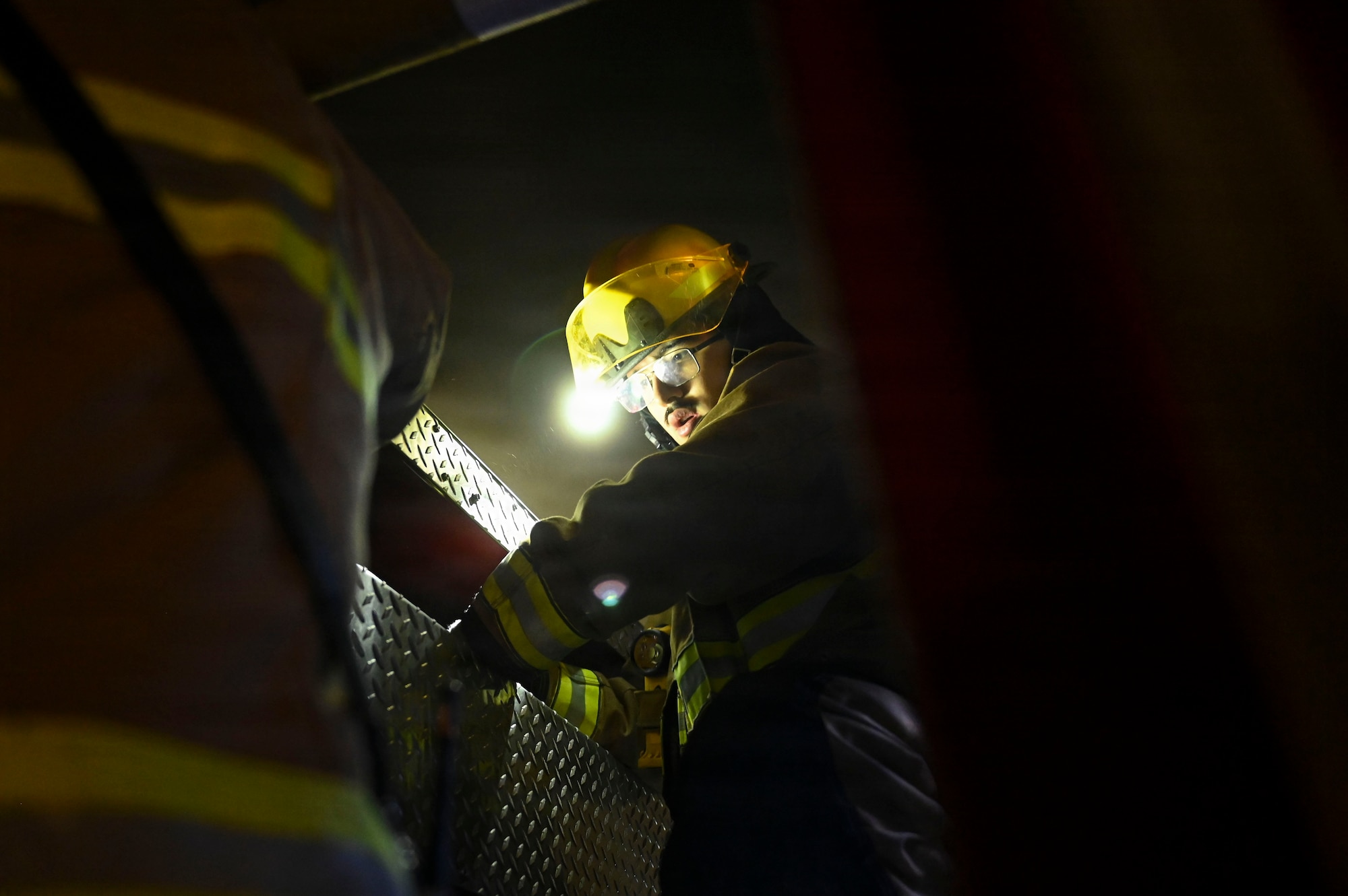 Fire fighter secures hose.