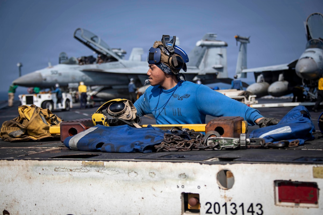 U.S. Navy Aviation Boatswain’s Mate (Handling) Airman Zyrus Rabosa operates a tractor on the flight deck of Nimitz-class aircraft carrier USS Abraham Lincoln (CVN 72), in the Arabian Sea, Feb. 20, 2026. Abraham Lincoln is deployed to the U.S. 5th Fleet area of operations to support maritime security and stability in the Middle East. (U.S. Navy photo by Mass Communication Specialist Seaman Aljay Monzales)