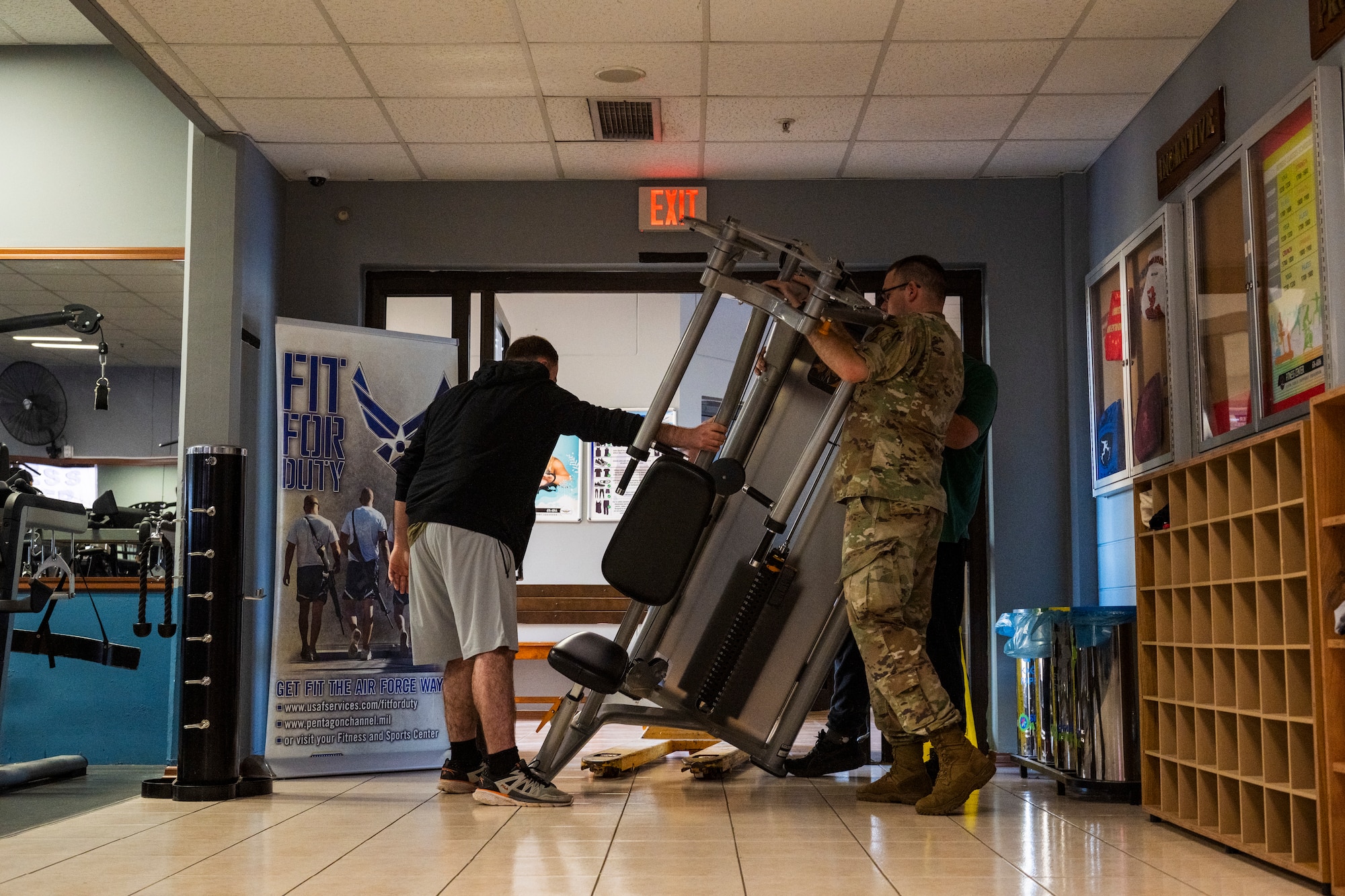 U.S. Airmen move a strength-training machine
