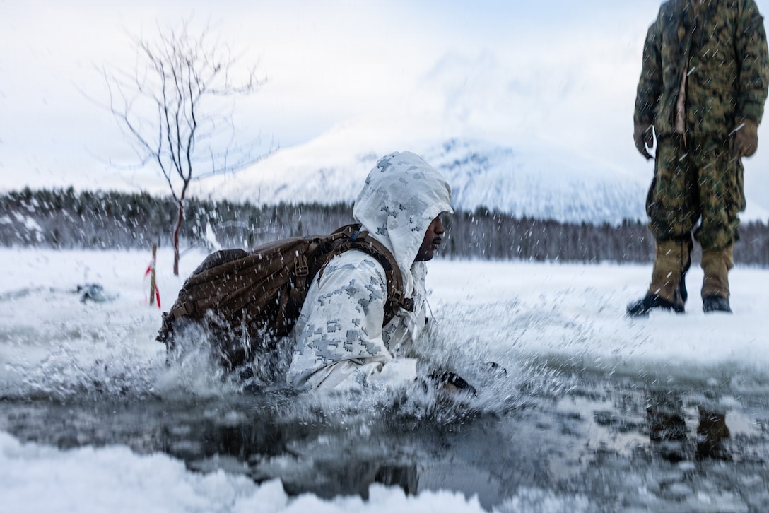 U.S. Marine Corps Cpl. Seth Moultrie, an infantry rifleman with 2nd Battalion, 6th Marine Regiment, 2nd Marine Division, participates in a polar plunge during cold weather survival training at exercise Cold Response 26 in Setermoen, Norway, Feb. 6, 2026. A key component of NATO's enhanced vigilance activity Arctic Sentry, exercise Cold Response 26 is a Norwegian-led winter military exercise designed to enhance collective defense capabilities and ensure U.S. readiness to rapidly deploy and seamlessly operate alongside NATO Allies in challenging arctic conditions. (U.S. Marine Corps photo by Cpl. Judith Ann Lazaro)