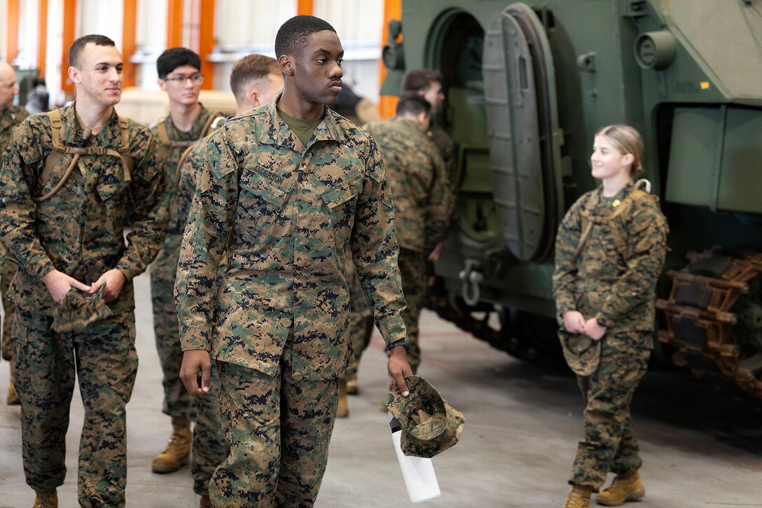 Midshipman 4th Class Chance Anderson of Warner Robins, Georgia, walks through a maintenance warehouse during a Blount Island Command-hosted tour Feb. 23, 2026, at Marine Corps Support Facility Blount Island, Florida. Naval Reserve Officer Training Corps students traveled nearly three hours from Tallahassee to observe how Marine Corps prepositioned equipment is maintained and prepared for global deployment. (Official Marine Corps photo by Dustin Senger)