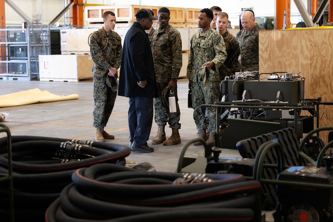 Retired Marine Corps Maj. Thurman Bobbett, head of the maintenance branch at Blount Island Command, explains corrective and preventive procedures Feb. 23, 2026, inside a warehouse at Marine Corps Support Facility Blount Island, Florida. Naval Reserve Officer Training Corps students observed how equipment is prepared for global deployment. (Official Marine Corps photo by Dustin Senger)