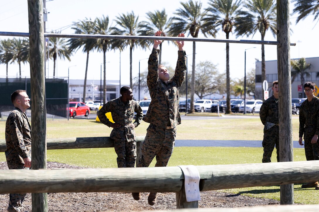Midshipman 2nd Class Caedon Hampton of Groveland, Florida, navigates an obstacle during a Blount Island Command-hosted demonstration Feb. 23, 2026, at Marine Corps Support Facility Blount Island, Florida. The event reinforced the physical standards and leadership expectations required of future Marine officers. (Official Marine Corps photo by Dustin Senger)