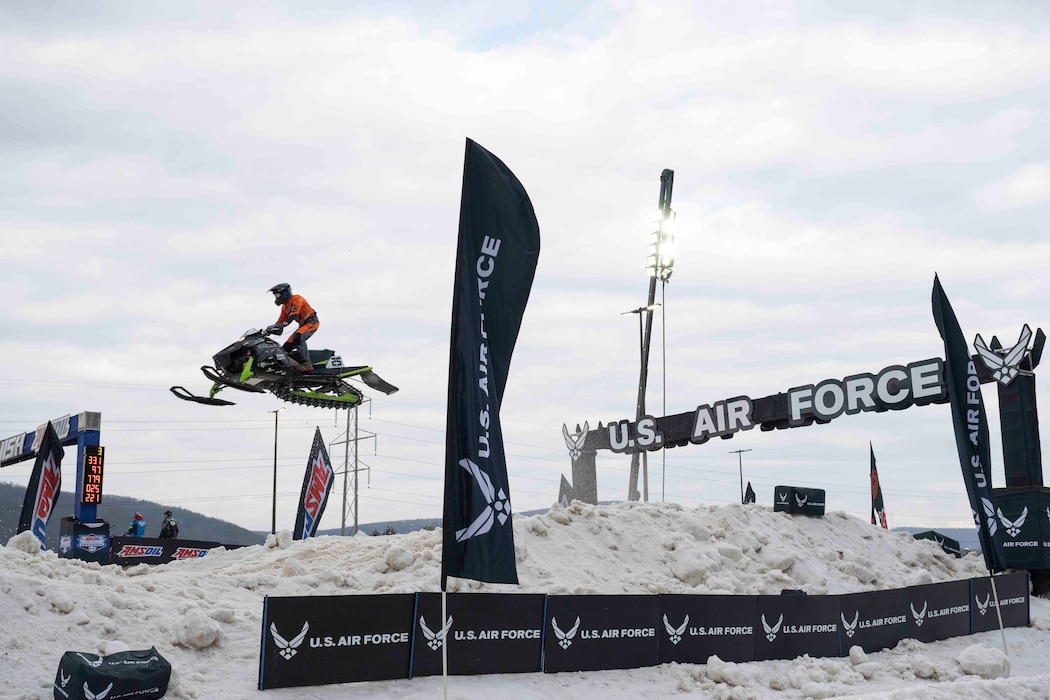A Snocross driver launches through the U.S. Air Force gate during the Seneca Allegany Snocross National at the Seneca Allegany Resort & Casino in Salamanca, N.Y., Feb. 20, 2026.