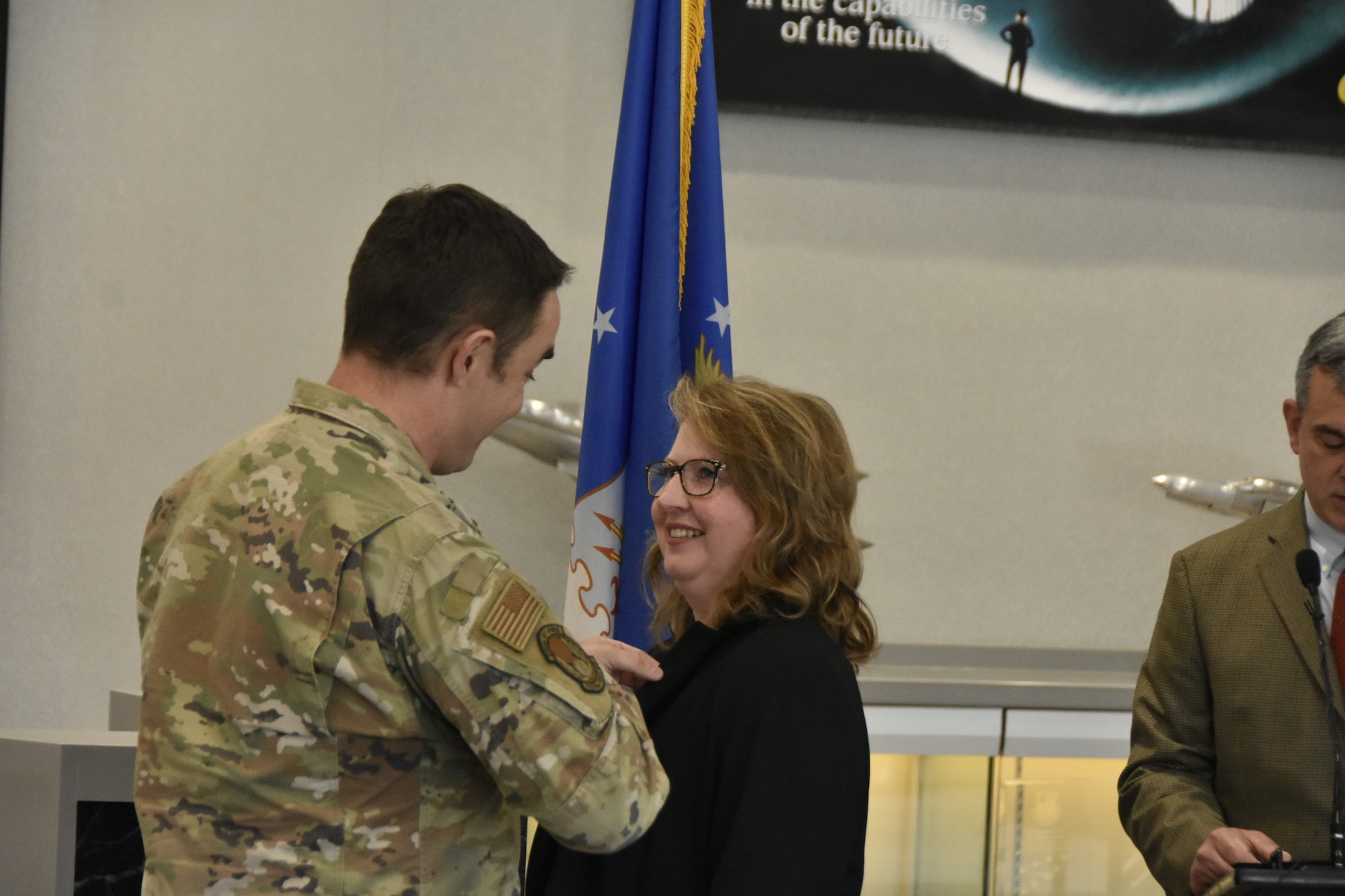 Suzanne Mitchell, director of Career and Technical Education for the Franklin County School District, right, receives her Honorary Commander lapel pin from then-717th Test Squadron Commander Lt. Col. Ryne Roady during the March 8, 2024, ceremony at Arnold Air Force Base, Tenn., to induct the first class of Arnold AFB Honorary Commanders. Arnold AFB is the headquarters of AEDC. (U.S. Air Force photo by Brad Hicks)