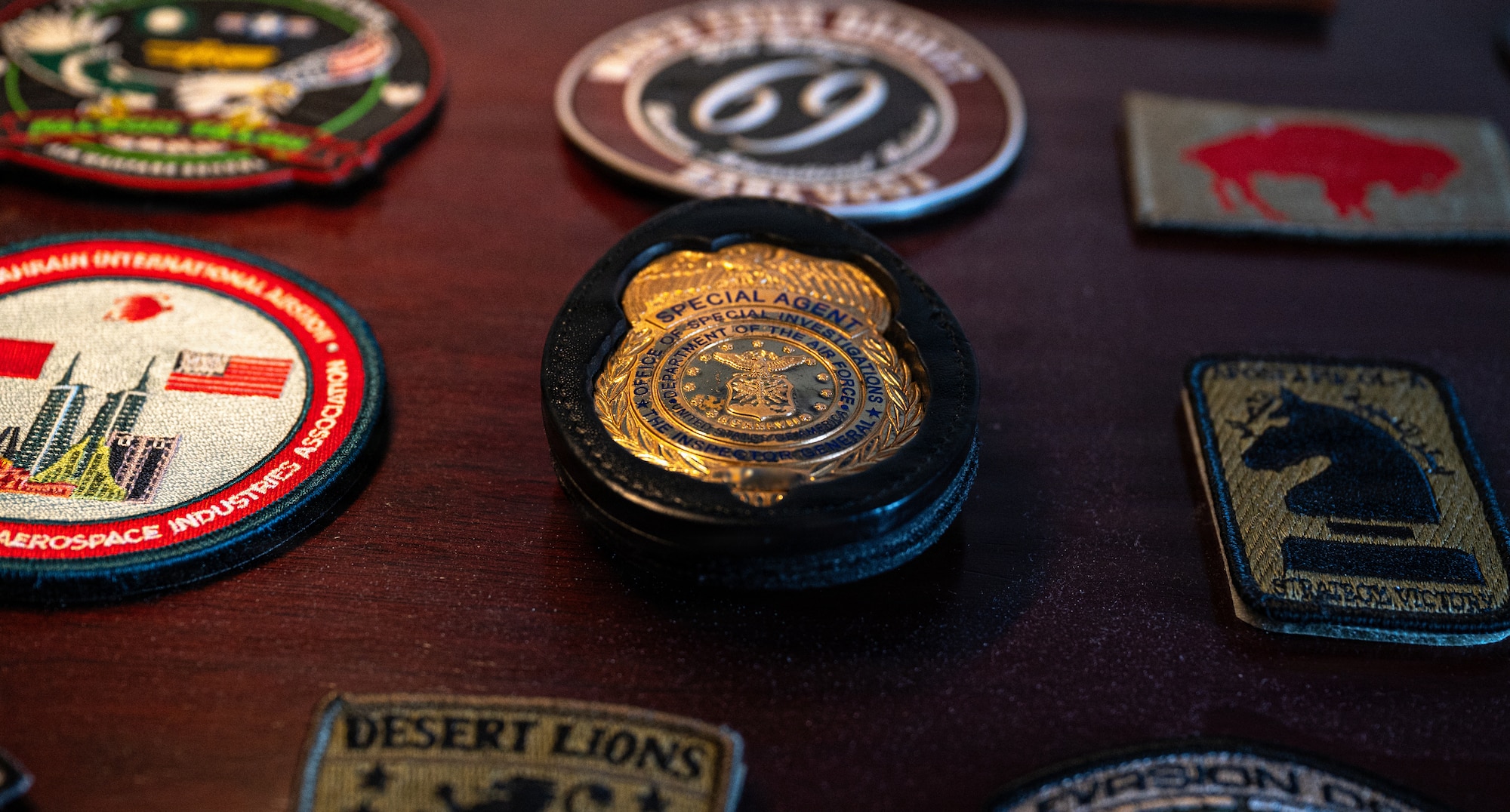 A U.S. Air Force Office of Special Investigations badge is displayed on a desk at Seymour Johnson Air Force Base, North Carolina, Feb. 11, 2026. AFOSI special agents protect Airmen, information and resources by conducting criminal investigations and counterintelligence operations in support of the 4th Fighter Wing mission. (U.S. Air Force photo by Airman 1st Class Holly Leonard)