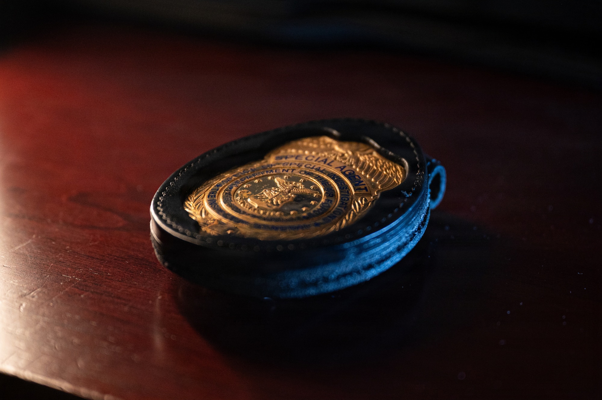 A U.S. Air Force Office of Special Investigations badge is displayed on a desk at Seymour Johnson Air Force Base, North Carolina, Feb. 11, 2026. AFOSI special agents protect Airmen, information and resources by conducting criminal investigations and counterintelligence operations in support of the 4th Fighter Wing mission. (U.S. Air Force photo by Airman 1st Class Holly Leonard)