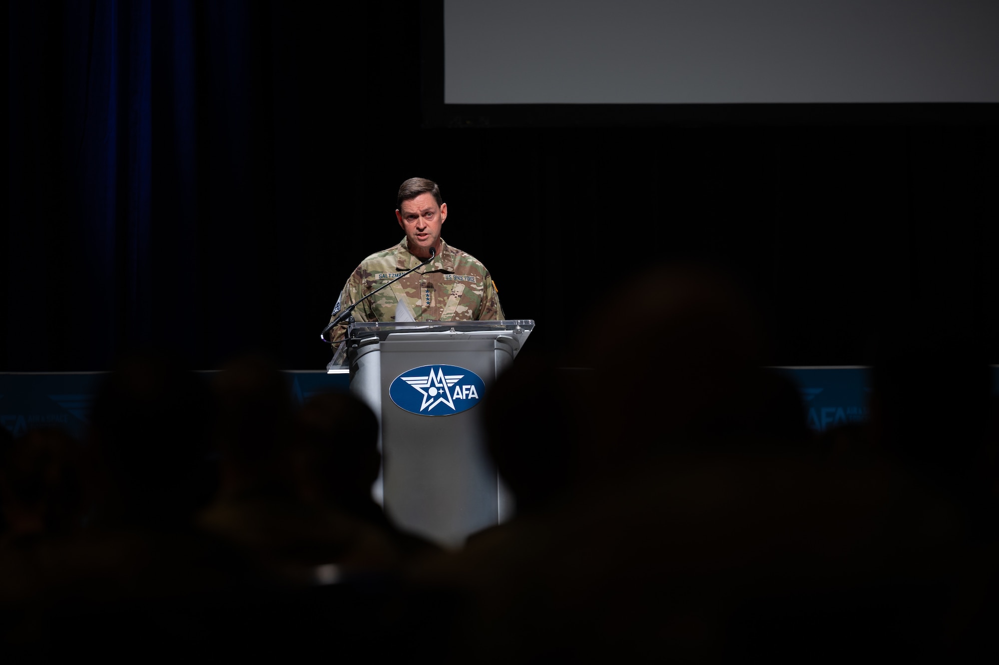 Gen Saltzman delivers a speech at a podium