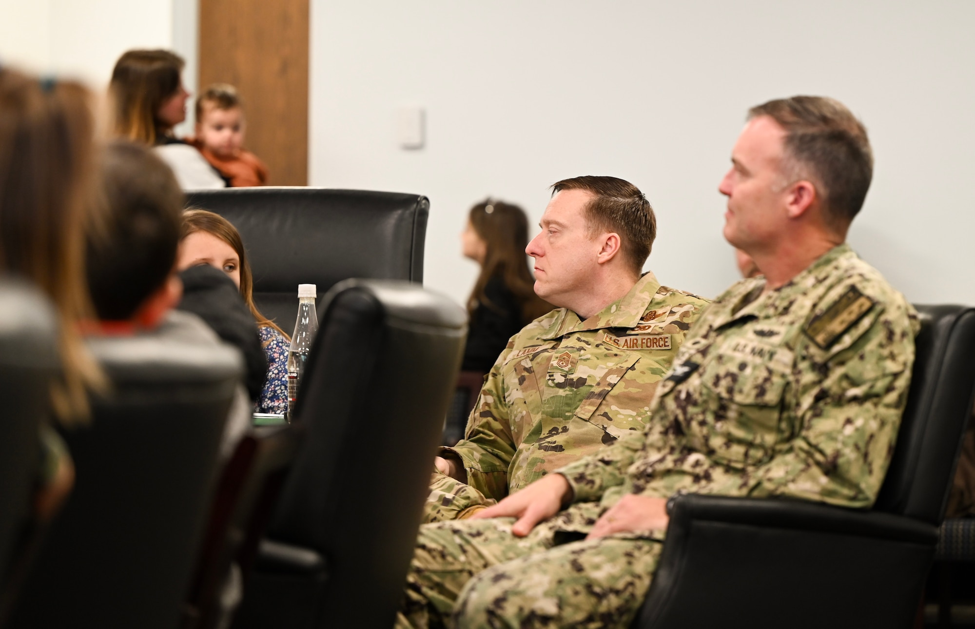 U.S. Air Force Chief Master Sgt. Ricky Lamm, 628th Air Base Wing command chief, and U.S. Navy Capt. Reed Koepp, Naval Support Activity commanding officer, listen to U.S. Air Force Col. Jason Parker, 628th Air Base Wing and Joint Base Charleston commander, speak of his Air Force career during a base visit at Joint Base Charleston.