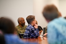 Military homeschoolers of the Lowcountry students listen to U.S. Air Force Col. Jason Parker, 628th Air Base Wing and Joint Base Charleston commander, as he shares facts about Joint Base Charleston during a wing leadership building tour at Joint Base Charleston.