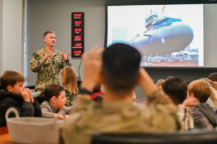 U.S. Navy Capt. Reed Koepp, Naval Support Activity commanding officer, explains the operations within a submarine to military homeschoolers of the Lowcountry students during a wing leadership building tour at Joint Base Charleston.