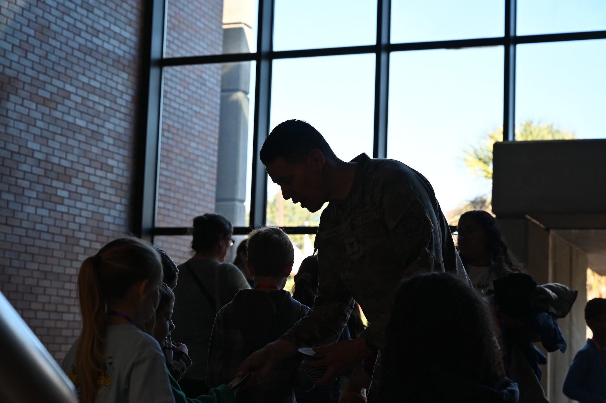 U.S. Air Force Col. Jason Parker, 628th Air Base Wing and Joint Base Charleston commander, hands out 628th ABW wing patches to the military homeschoolers of the Lowcountry.
