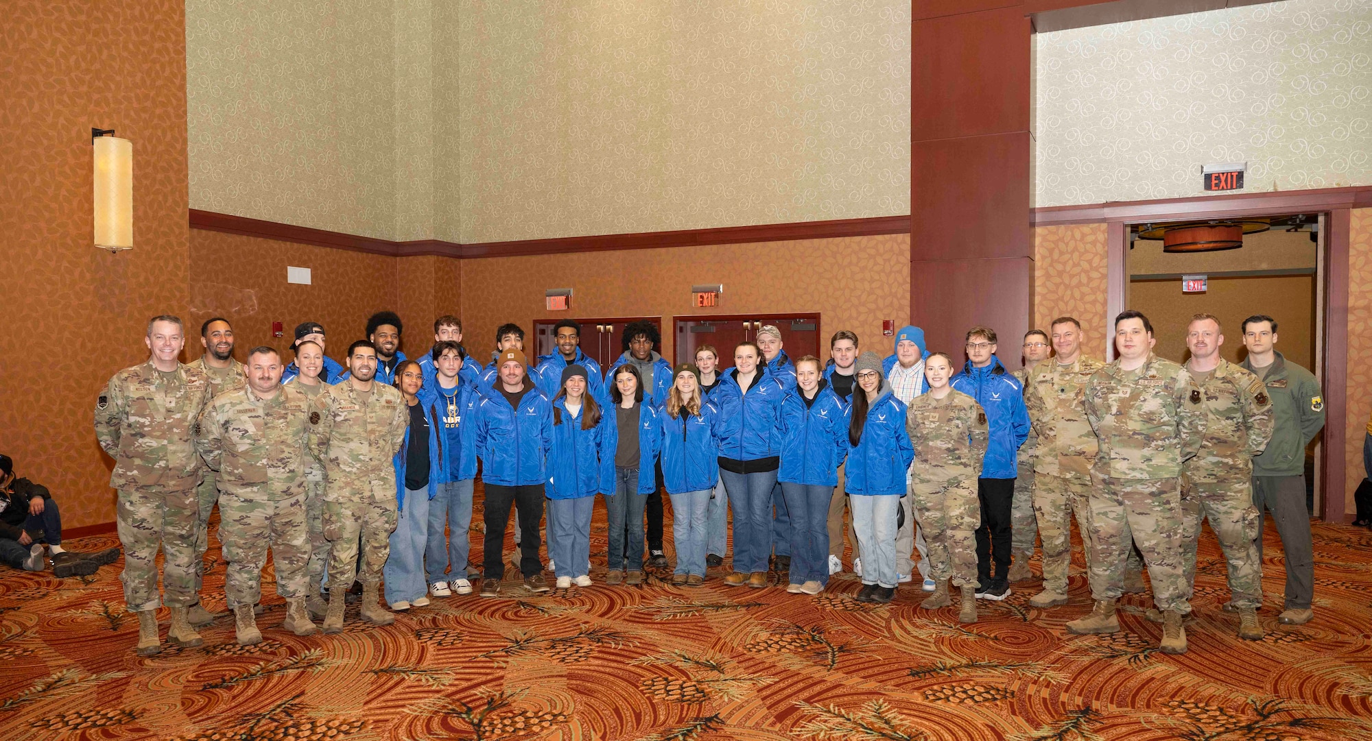 Brig. Gen. Jeffrey W. Nelson (left), commander of the Air Force Accessions Center and Air Force Recruiting Service; Airmen from the 313th Recruiting Squadron; delayed entry program members; and Tech. Sgt. Jamie Gardner, state marketing and advertising noncommissioned officer in charge for the Kansas Joint Force Headquarters and one of the U.S. Air Force’s 2025 Outstanding Airmen of the Year, pose for a group photo