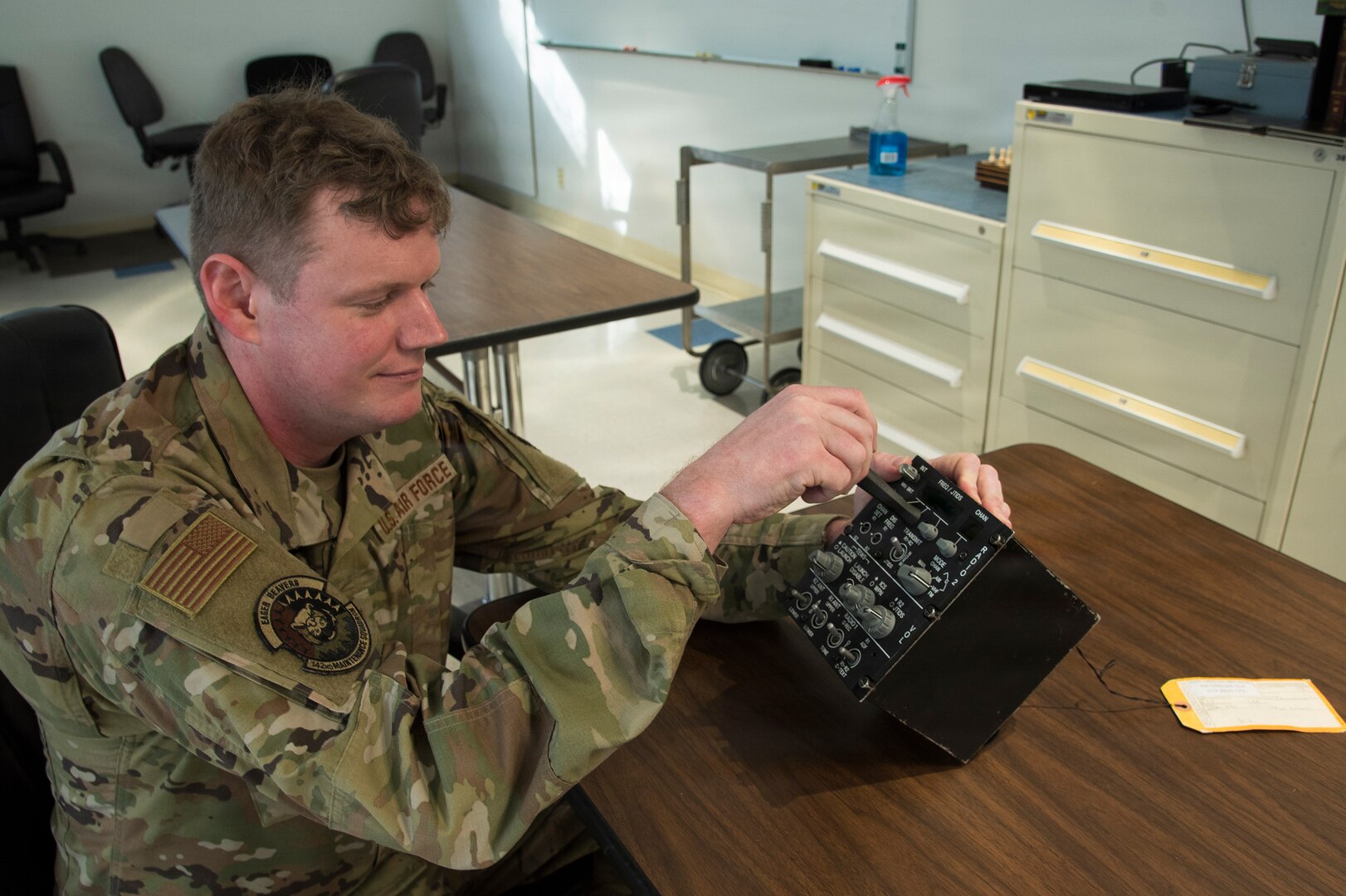 Staff Sgt. Kenneth Fritz adjusts the intercommunication control panel with dial adjuster he manufactured, Portland Air National Guard Base, Oregon, Jan 31, 2026.